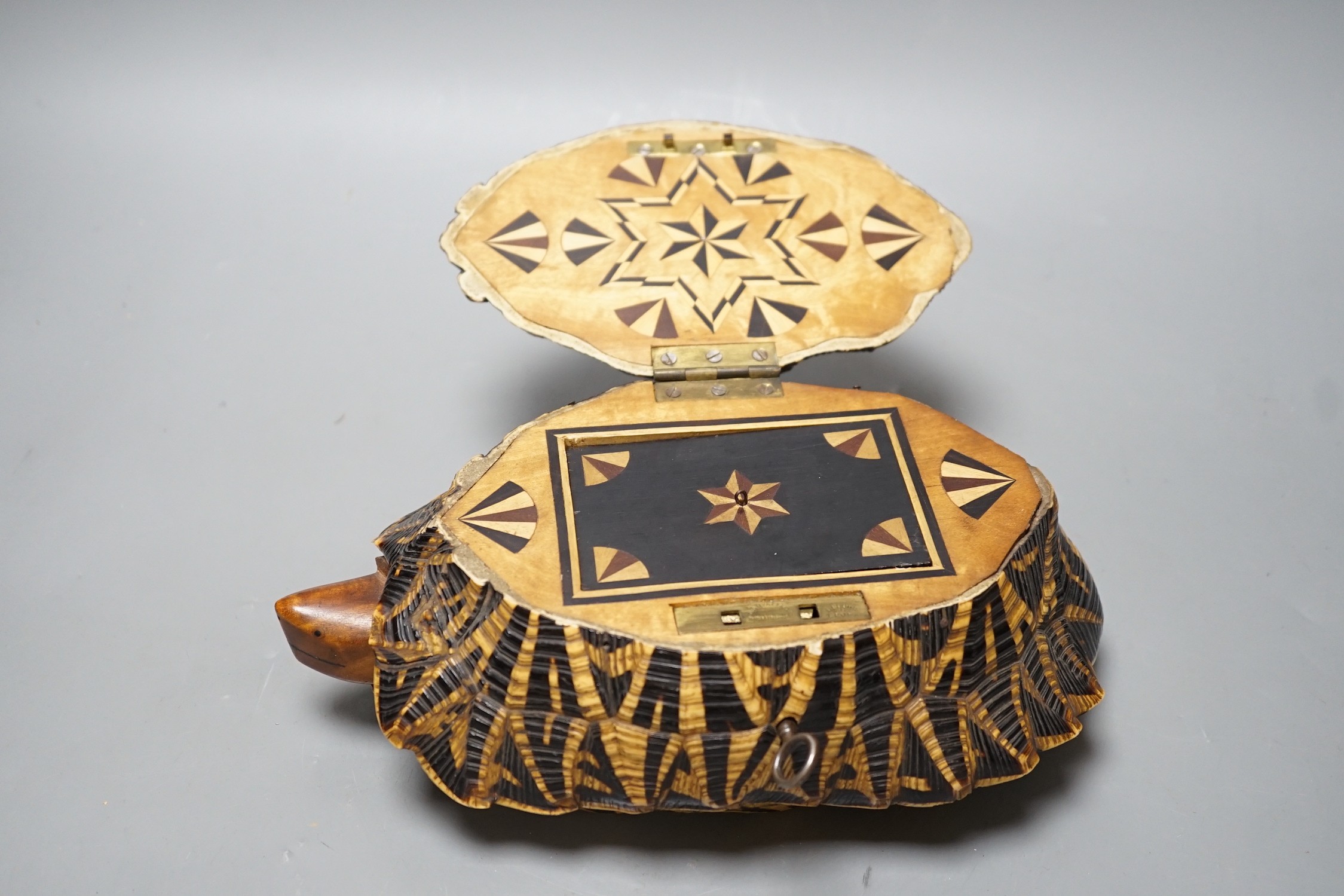 Early 20th century Ceylonese tortoise trinket box, with marquetry inlaid interior, 24.5 cm wide